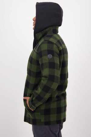 A person in profile view wears a green and black checkered Swanndri Hudson Jacket with a black hood, standing against a plain light background—ideal outdoor wear made from soft New Zealand wool.