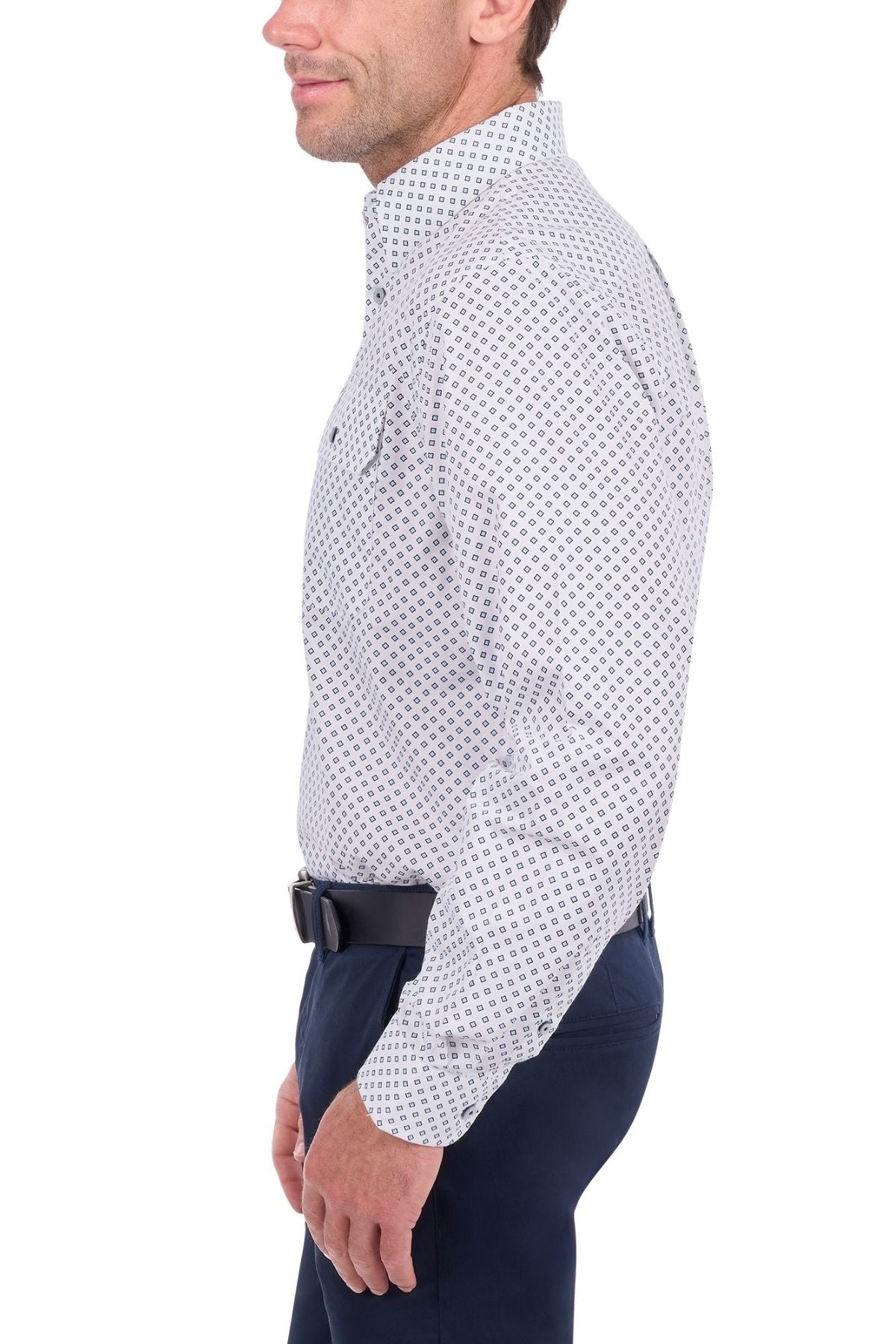 A man in a Thomas Cook Albie Shirt and dark pants stands in profile against a white background.