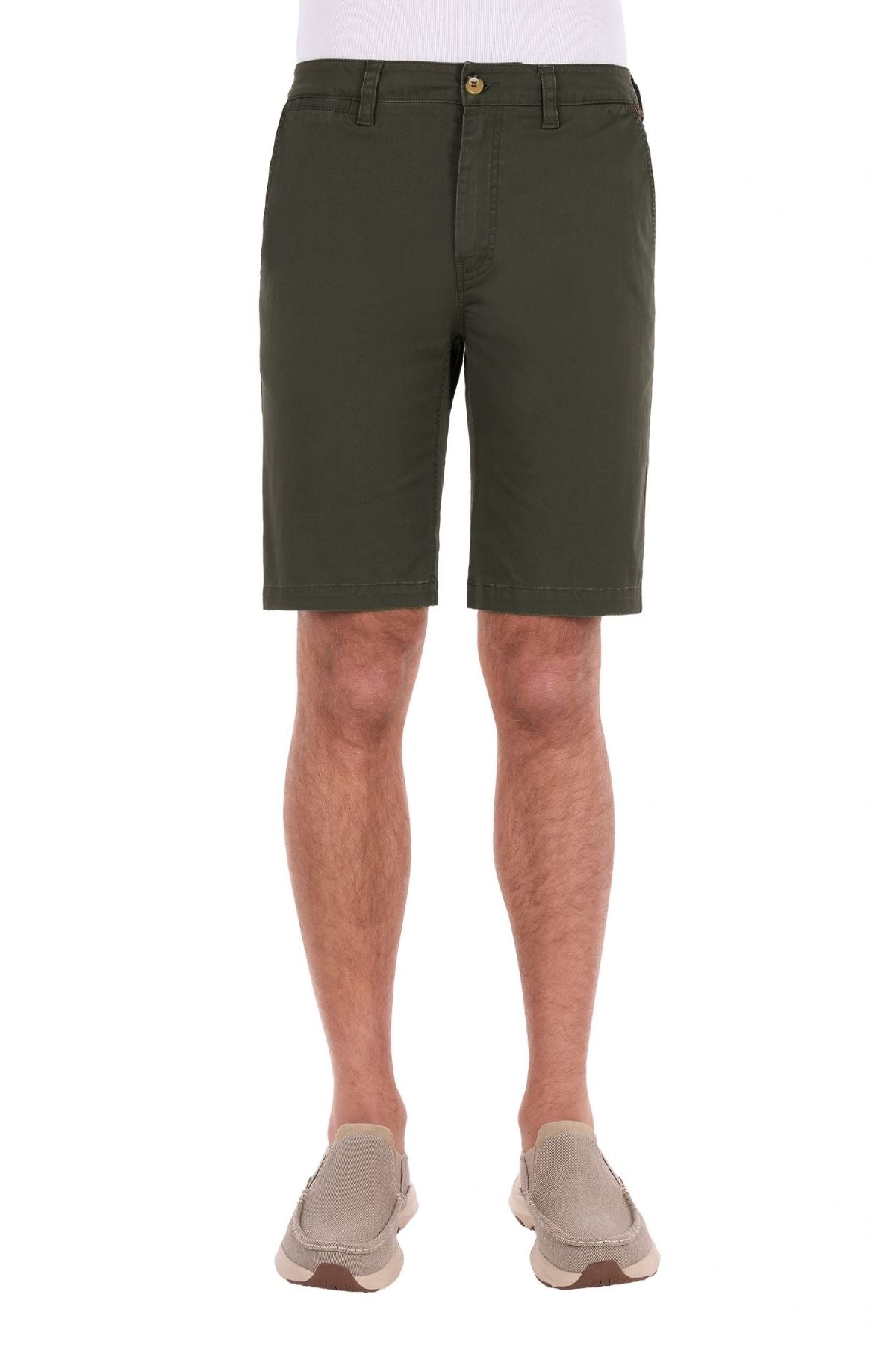 Dressed in olive green Thomas Cook Harrison Shorts, made from comfortable stretch fabric, and light brown slip-on shoes, a person stands facing forward against a white background.