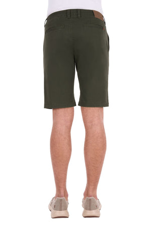 A person wearing olive green Thomas Cook Harrison Short, made from stretch fabric, paired with light beige sneakers, is shown from the back against a plain white background.