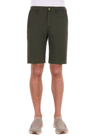 Dressed in olive green Thomas Cook Harrison Shorts, made from comfortable stretch fabric, and light brown slip-on shoes, a person stands facing forward against a white background.