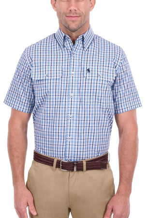 A man wearing the Thomas Cook Jude Short Sleeve Shirt, a blue and white plaid button-up made from 100% cotton, paired with khaki pants and a brown belt, stands against a white background.