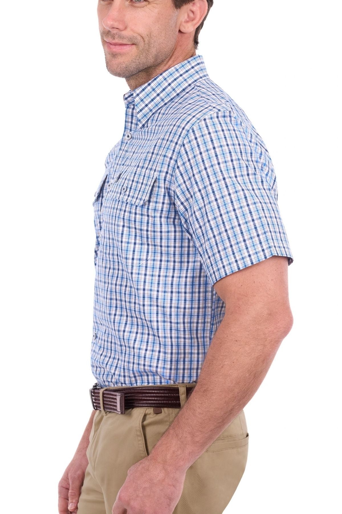 A man wearing the Thomas Cook Jude Short Sleeve Shirt in blue and white plaid and khaki pants stands in profile, facing left, against a plain white background.