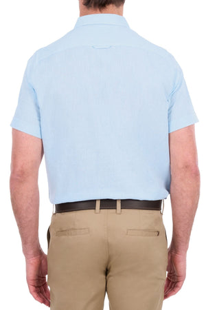 A man wearing the Thomas Cook Linen Short Sleeve Shirt in light blue and khaki pants, viewed from behind, standing against a white background.