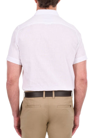 A man is shown from the back wearing the Thomas Cook Linen Short Sleeve Shirt in white and light brown pants with a dark belt, standing against a plain white background.