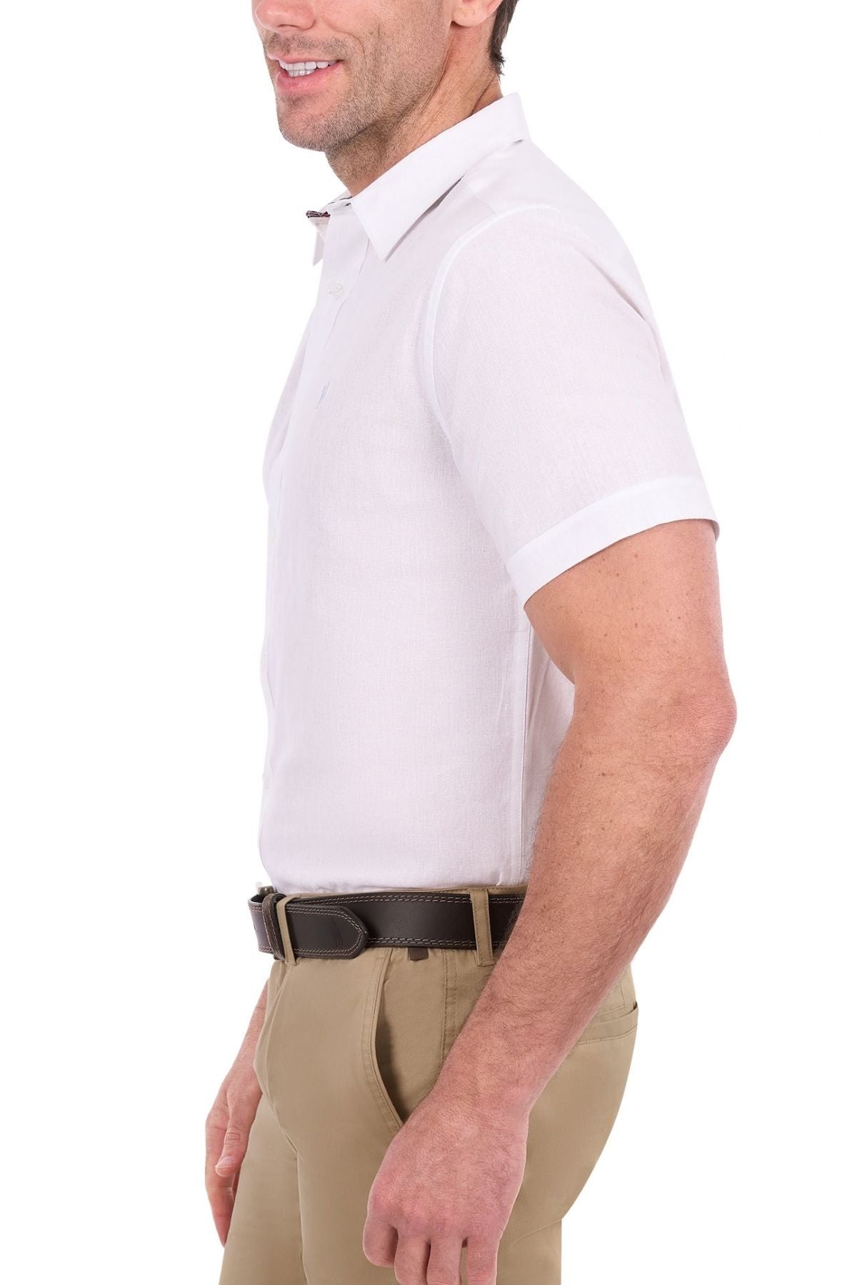 A man wearing the Thomas Cook Linen Short Sleeve Shirt in white and khaki pants with a dark brown belt, standing sideways and smiling against a white background.