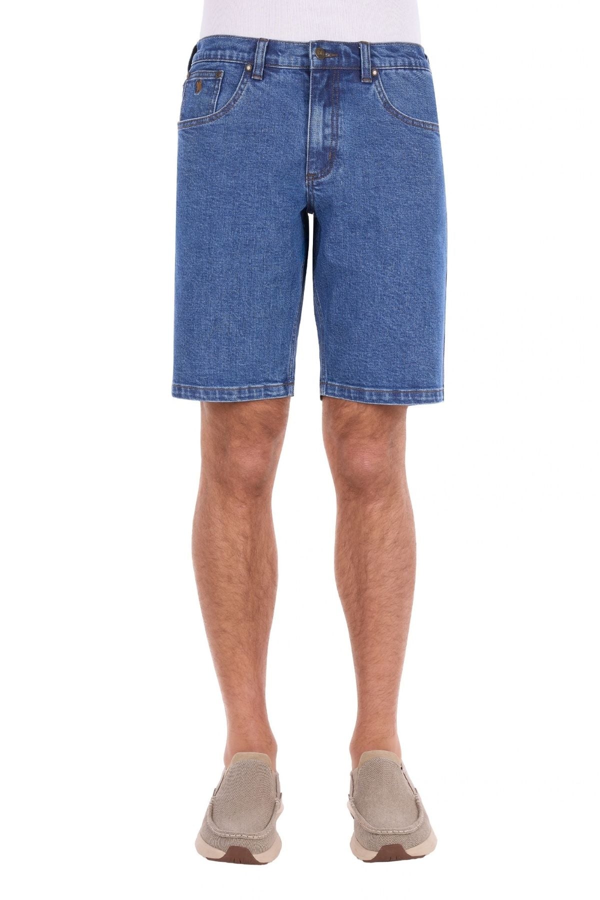 A person wearing the Thomas Cook Lochie Short denim shorts and beige loafers is standing facing forward against a white background.
