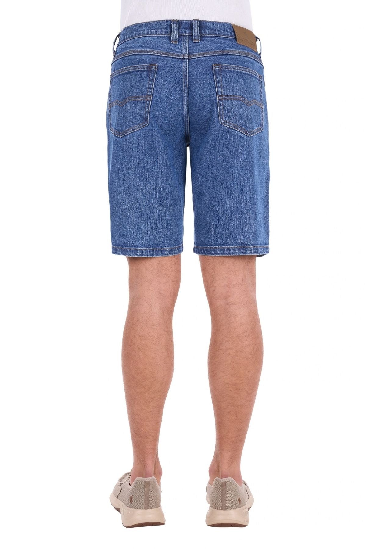 A person wearing the Thomas Cook Lochie Short and beige sneakers, shown from the back. The rugged denim shorts feature two back pockets and visible stitching. The background is plain white.