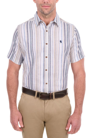 A man wearing the Thomas Cook Max Short Sleeve Shirt, featuring casual striped cotton linen styling, paired with tan pants and a dark brown belt, stands against a white background.