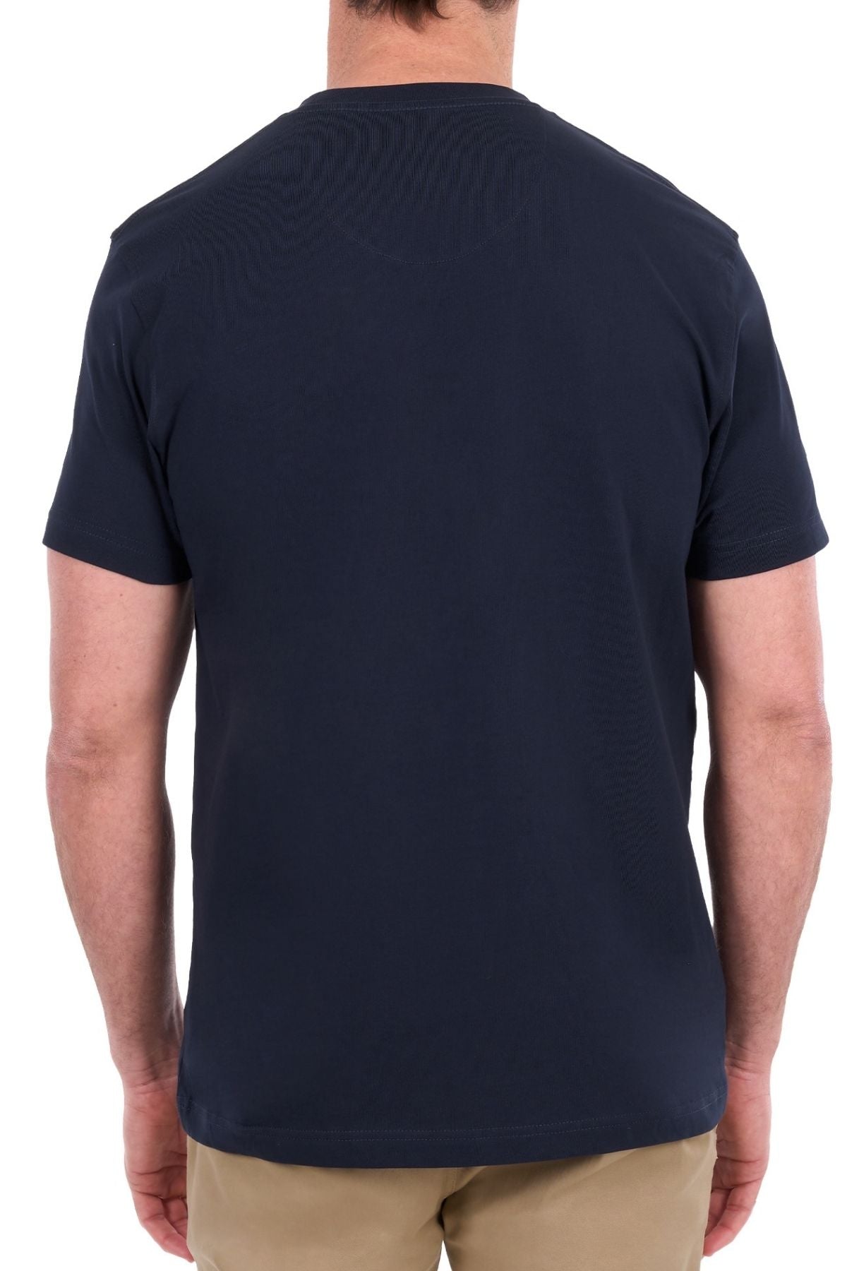 A person is standing with their back to the camera, wearing a Thomas Cook Nathan Tee in plain navy blue, made from 100% cotton, paired with beige pants against a white background.