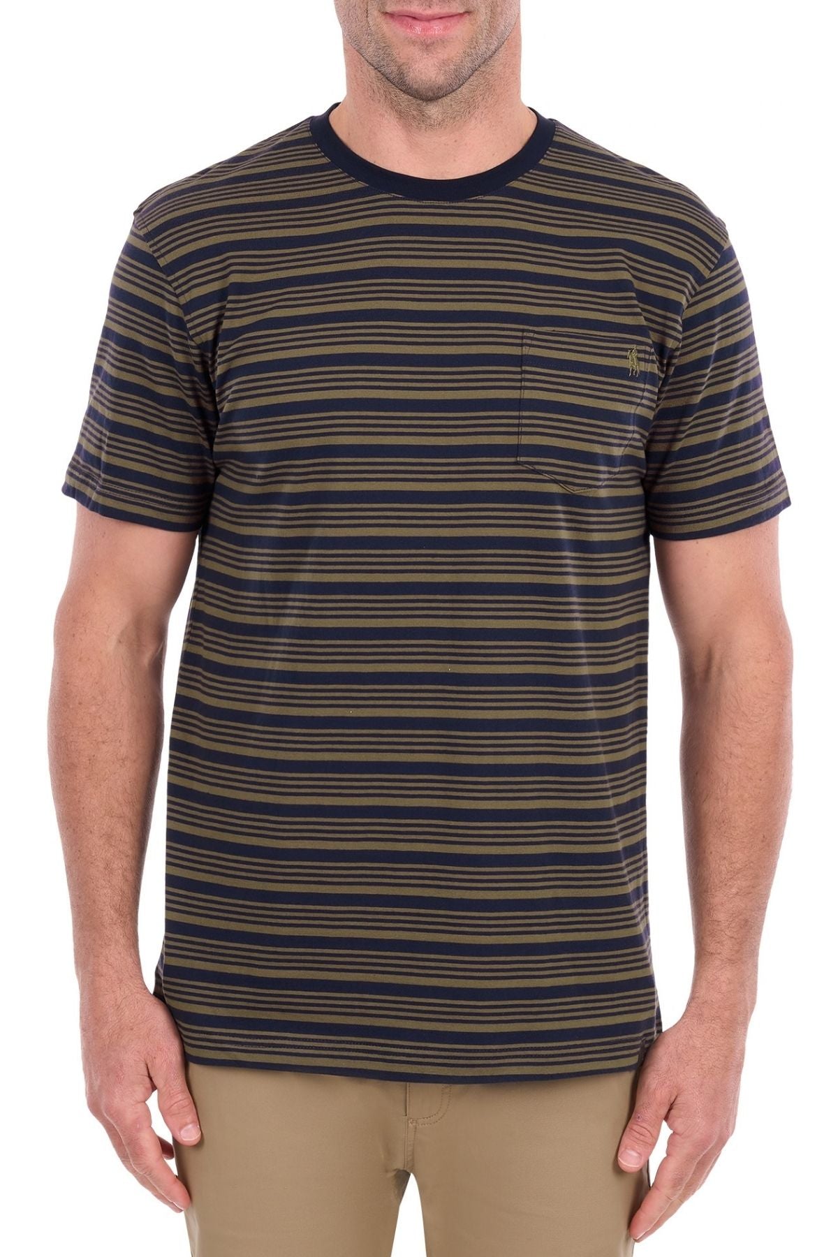 A man wearing the Thomas Cook Oliver Tee—a short-sleeve, navy and olive striped shirt made from soft cotton jersey with a chest pocket—paired with tan pants, stands against a white background.