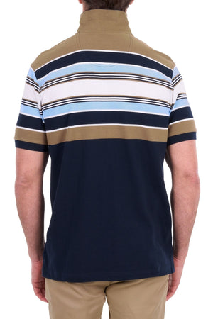 A man is seen from the back wearing the Thomas Cook Phillip Polo, a short-sleeve cotton pique shirt featuring multi-colour stripes in navy, blue, white, and brown. He is also dressed in tan pants.
