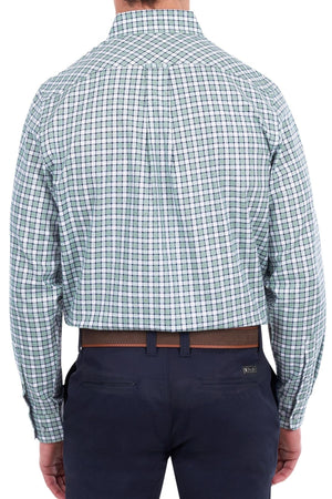 Wearing the Thomas Cook Rory Shirt, a long-sleeve cotton check shirt in green and white, neatly tucked into navy pants, the person is shown from the back.
