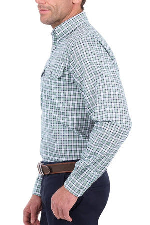 A man is shown from the side against a white background wearing the Thomas Cook Rory Shirt in blue, green, and white plaid with navy pants.