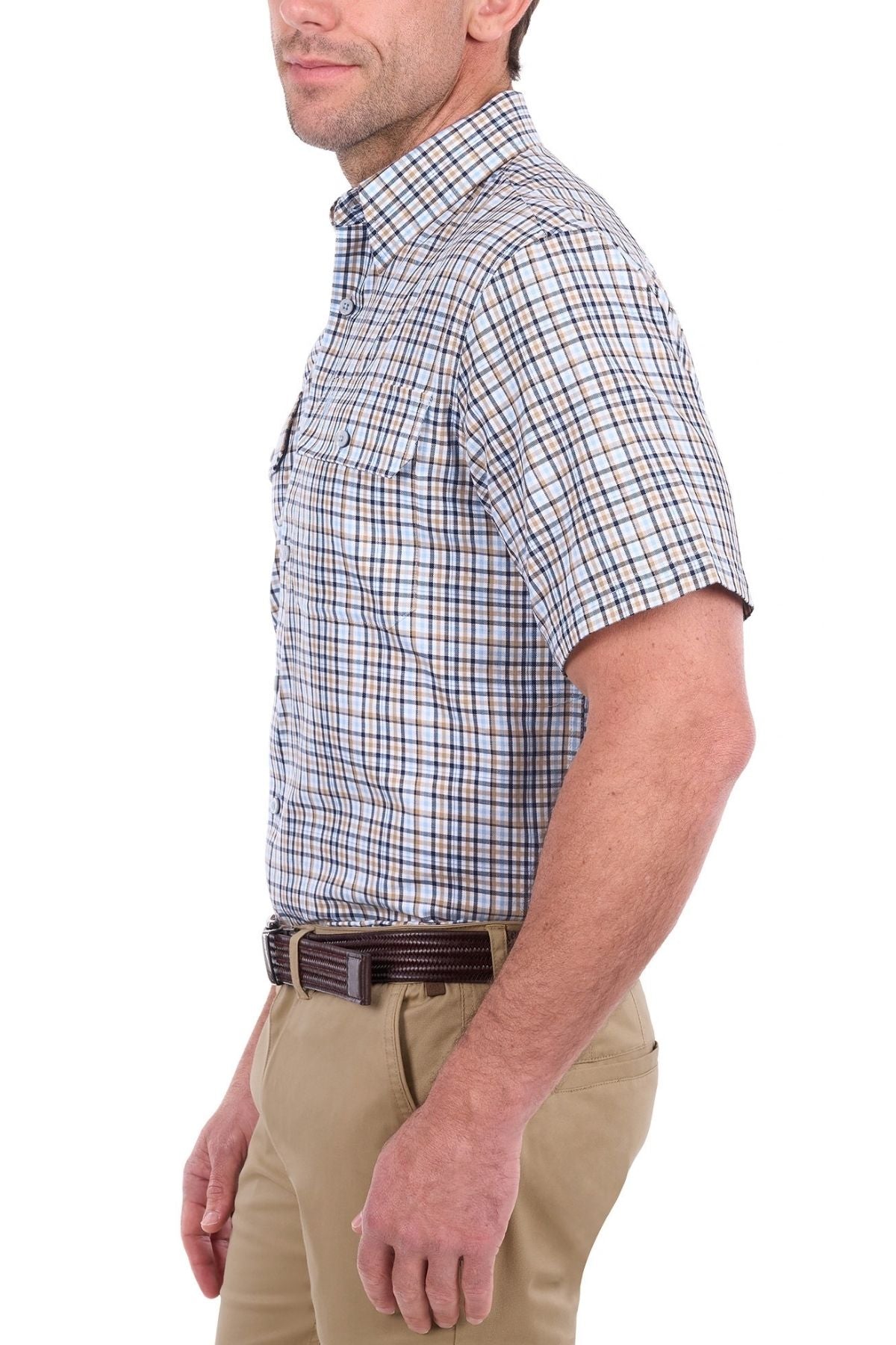 A man wearing the Thomas Cook Ted Short Sleeve Shirt, featuring blue and brown cotton checks, paired with tan pants and a dark belt, stands in profile against a white background.