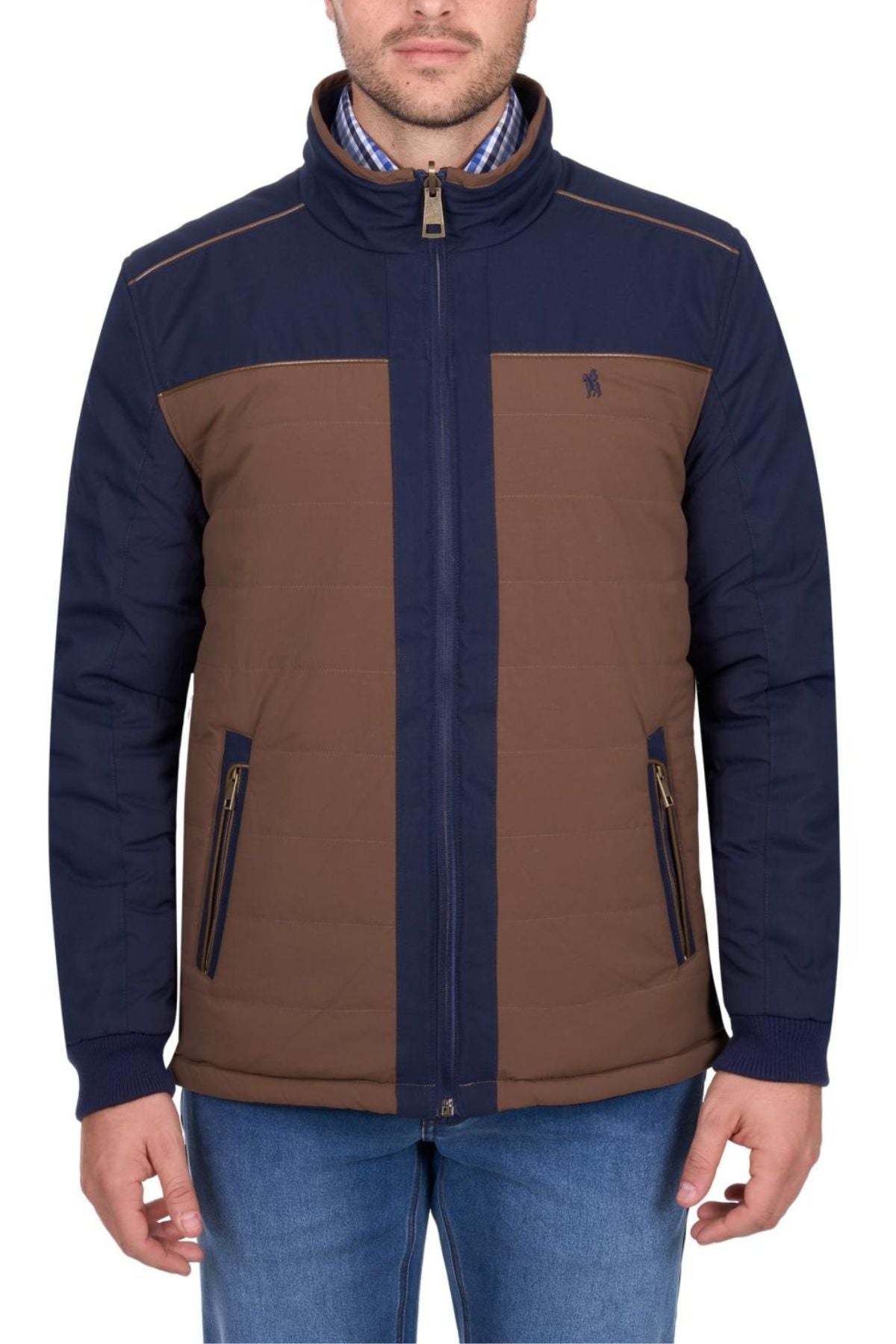 A man wears the Thomas Cook Toby Reversible Jacket with navy sleeves and shoulders, brown front and back panels, zippered front and pockets, paired with blue jeans. Only the lower part of his face is visible.