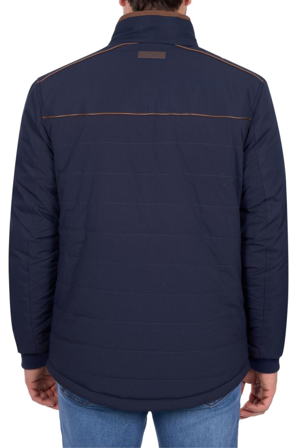 Someone wearing the Thomas Cook Toby Reversible Jacket in dark blue with brown piping across the upper back is seen from behind, paired with blue jeans.