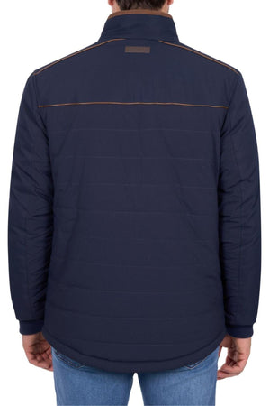 Someone wearing the Thomas Cook Toby Reversible Jacket in dark blue with brown piping across the upper back is seen from behind, paired with blue jeans.