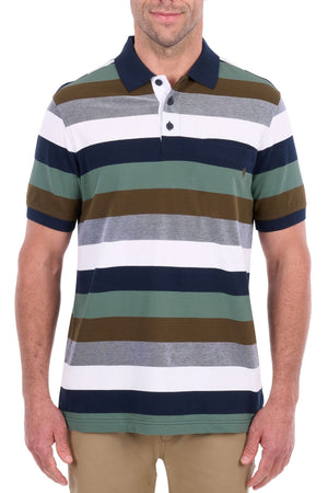 A man dressed in the Thomas Cook Wayne Polo—a short-sleeve, collared shirt made from pure cotton pique and designed with horizontal stripes in green, navy, white, grey, and brown—paired with khaki pants.