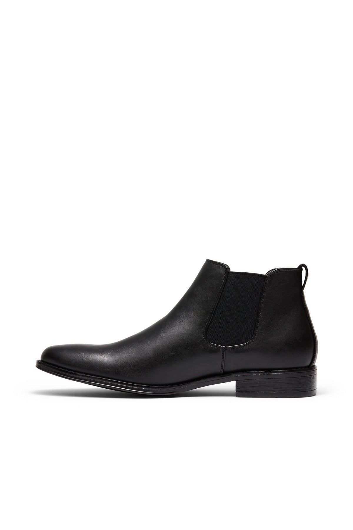The UNcut Canterbury Boot is a durable black leather Chelsea boot with elastic side gussets, a rounded toe, low heel, and back pull tab, displayed in side profile against a white background.
