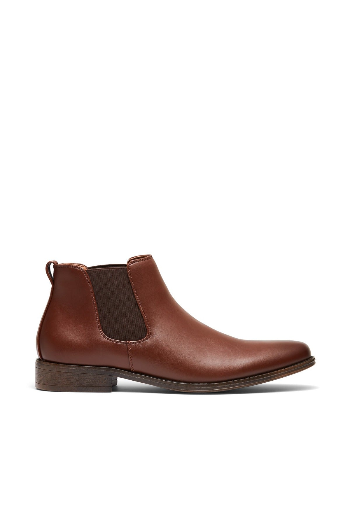 The UNcut Canterbury Boot is a brown leather Chelsea boot featuring distinctive side gussets and a low heel, displayed on a white background.