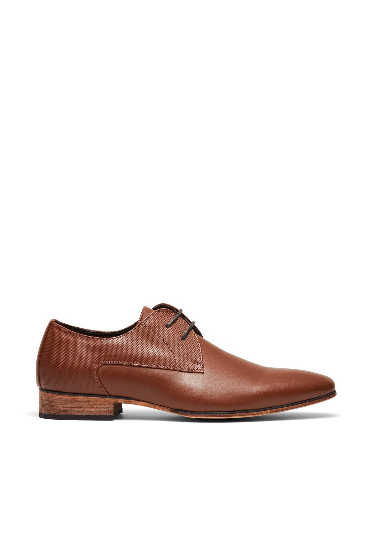 The UNcut Chartwell Shoe, ideal for corporate settings or formal events, features a sleek brown leather design with lace-up closure and a low wooden heel. Set against a white backdrop, it highlights its polished finish.