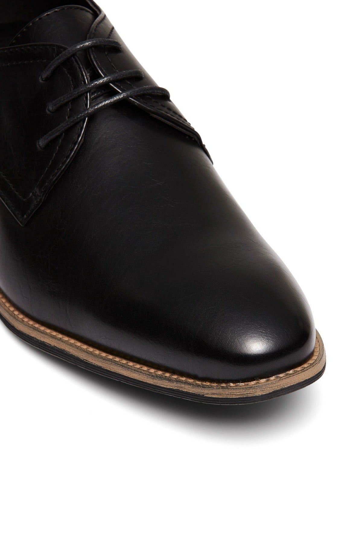 Close-up of the black UNcut Rhine Shoe featuring black laces and a brown welt, highlighting the toe, upper, and sole—ideal for formal events.