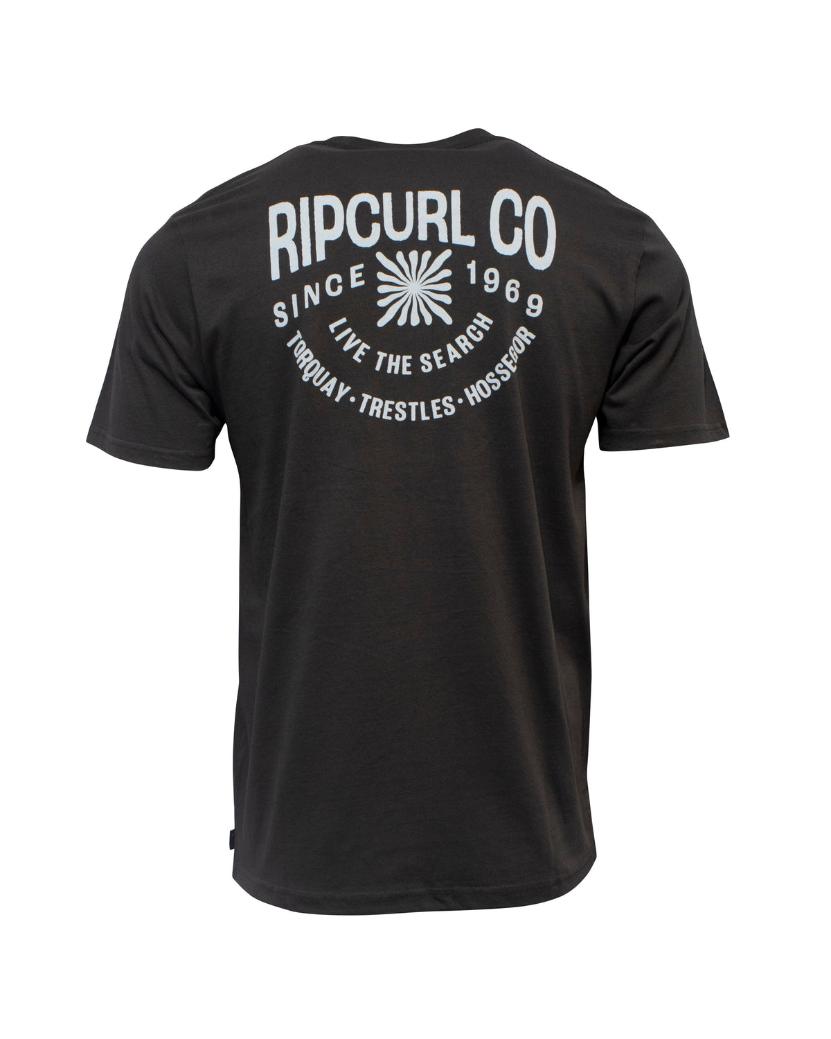 The Rip Curl Cosmic Burst Tee is a black 100% cotton T-shirt featuring "RIP CURL CO SINCE 1969 LIVE THE SEARCH TORQUAY • TRESTLES • HOSSEGOR" and a circular white back print—ideal for casual style.