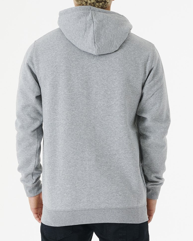 Facing away, someone is wearing the Rip Curl Corp Icon Zip Thru, a comfortable light gray hoodie with the hood pulled up and long sleeves, paired with dark pants, set against a plain white background.