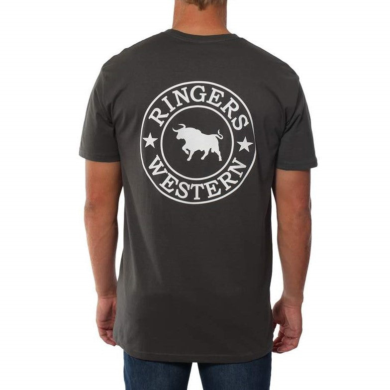 The person is wearing a Ringers Western Signature Bull Original Fit T-Shirt, which is 100% cotton, dark-colored, and features a circular logo on the back with a bull in the center and "Ringers Western" text surrounded by stars. The person is facing away from the camera.