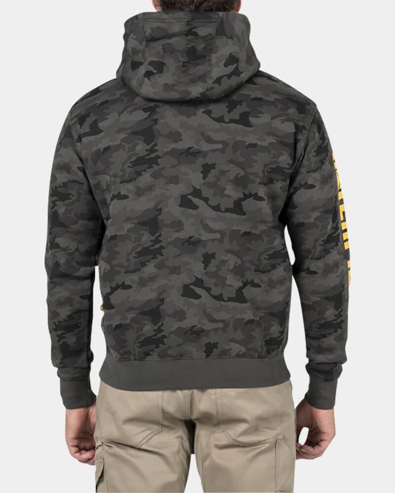 A person is shown from the back wearing a CAT Trademark Banner Hooded Sweat in gray camouflage with fleece lining, hood up, and khaki cargo pants. The background is plain white, and the sleeve features yellow text.
