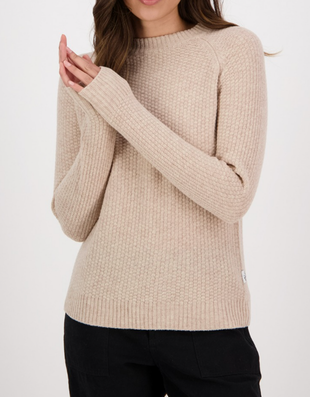 A person wearing the Swanndri Hayes Park Waffle Knit Crew in beige and black pants stands with hands clasped against a plain white background.
