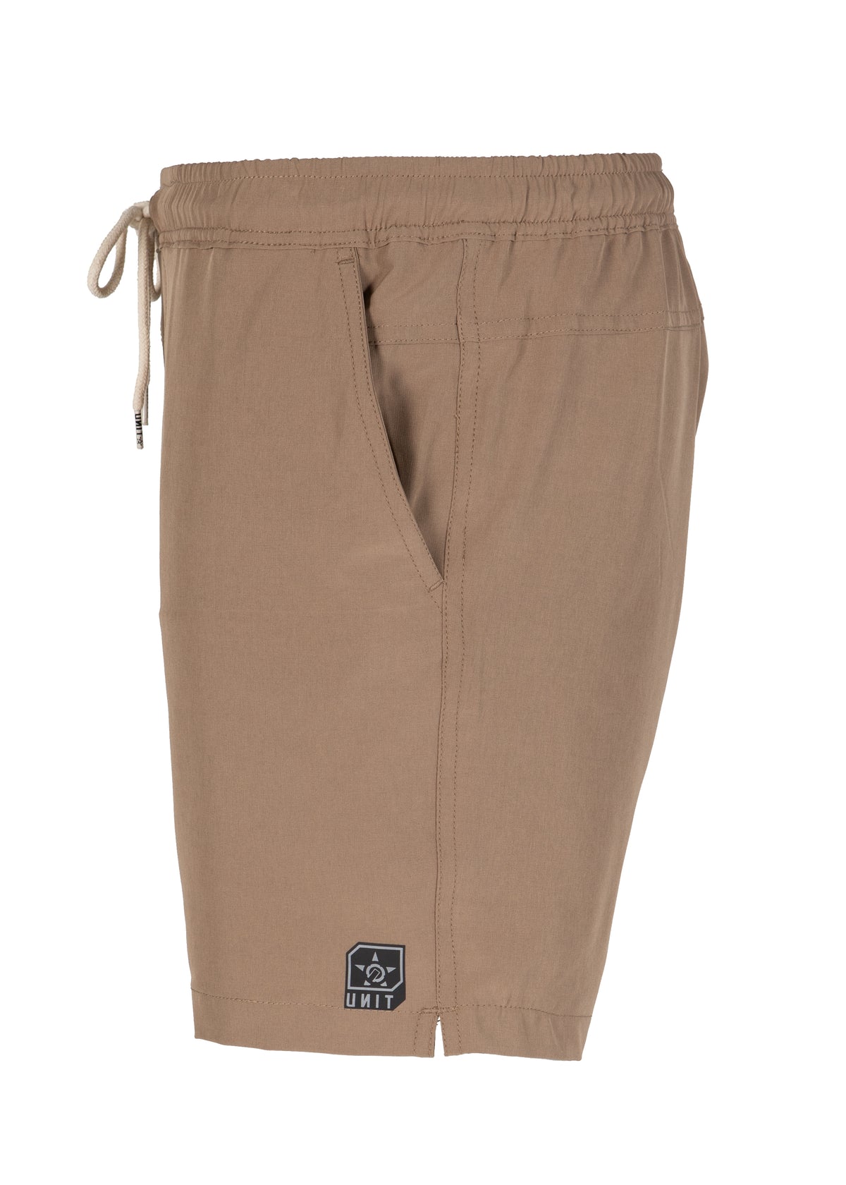 The UNIT Boardwalk Elastic Waist Short in light brown features a drawstring, side pocket, small black and white logo patch near the hem, and quick-dry fabric for all-day comfort. Photographed against a white background.