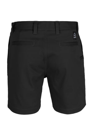 The UNIT Trench Stretch Work Short in black, shown from the back, features belt loops, a reinforced button, two back welt pockets, and a small stitched logo patch on the upper waistband.