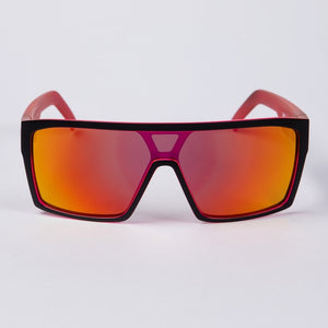 The UNIT Command Polarised Eyewear boasts a bold, modern design with a lightweight frame in glossy black and red. Its large, rectangular lenses are polarised and feature a gradient tint transitioning from red to orange, creating a vibrant, reflective appearance. These stylish shades provide superior UV protection against harmful rays.