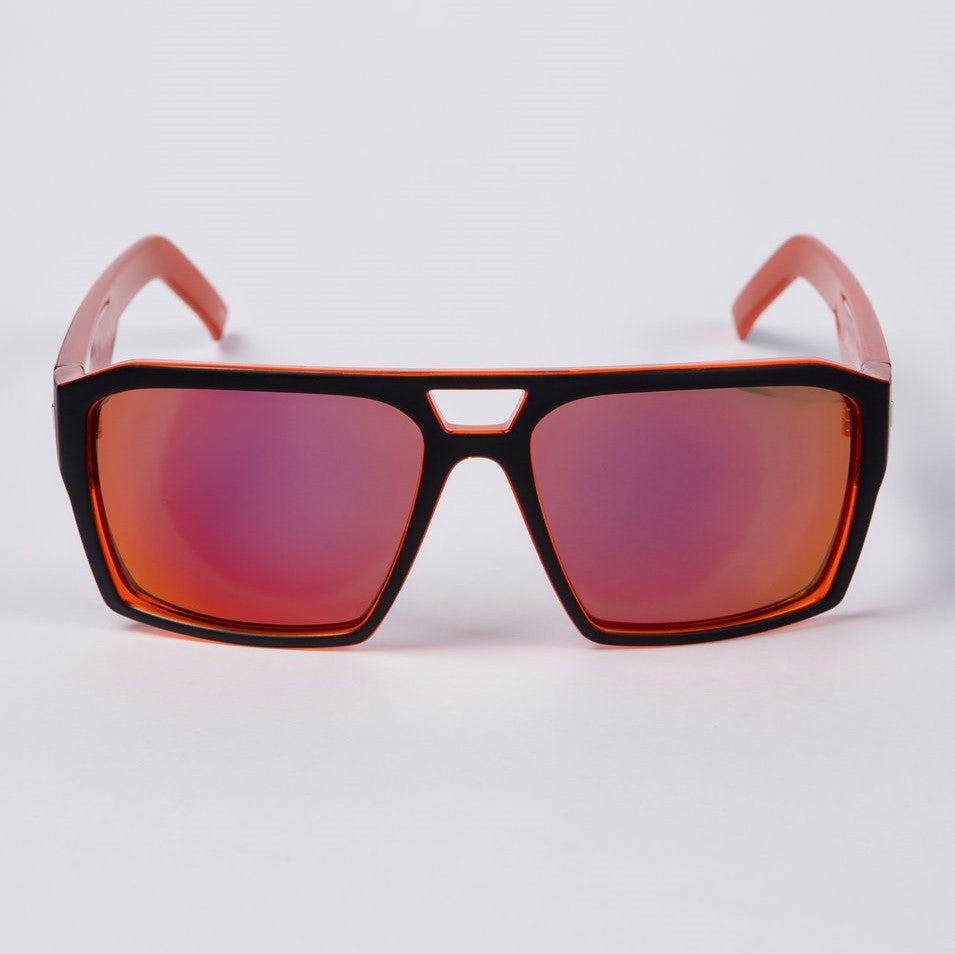The UNIT Vault Polarised Eyewear, featuring red frames and matching red-tinted lenses, is showcased against a white background. These sunglasses have a rectangular shape with a small bridge over the nose area, providing excellent sun glare reduction and UV protection for your eyes.