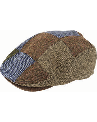 A close-up image of the Dot & Co Wool Blend Patchwork Cap, showcasing its construction from a variety of tweed fabrics in shades of brown, green, and blue. The short brim elegantly complements the rich textures and patterns, including herringbone, checkered, and solid designs.