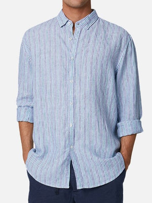 A man wearing the Industrie The Grenadines Linen Shirt in green/light blue with a relaxed fit and rolled-up sleeves, standing with his hands in his pockets.