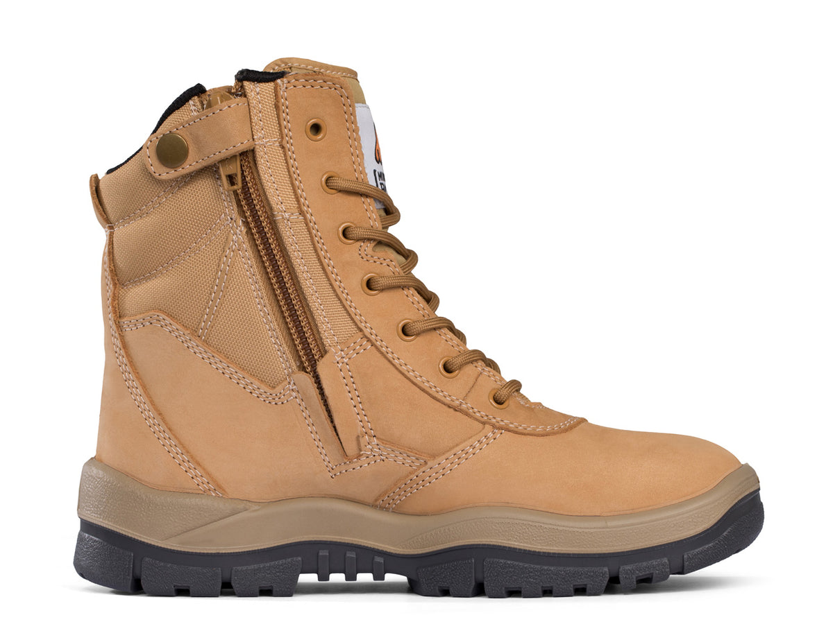 The Mongrel High Leg ZipSider Safety Boot 251050 in tan showcases a side zipper and lace-up front, set against a white background. It boasts a slip-resistant sole, dark rubber outsole, and padded ankle collar for enhanced comfort and support. The design is completed with reinforced stitching and durable fabric panels.