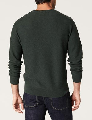 A man is seen from behind wearing the Blazer Mason Cotton Textured Crew Neck in dark green with dark blue jeans against a plain light background.