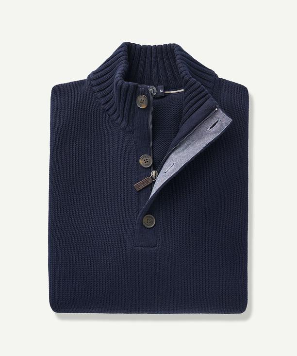 The Gazman Chunky Button Neck Knit is a regular-fit, navy blue jumper featuring long sleeves, a ribbed high collar lined with gray fabric, and a partial button placket with three brown buttons and a zipper. Crafted from soft cotton, it comes neatly folded.