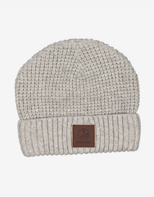The Swanndri Newgale Beanie is a stylish gray waffle-knit beanie, featuring a folded brim and an elegant leather patch logo on the front.
