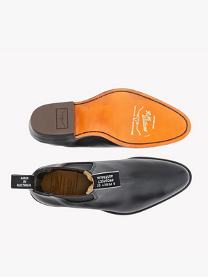 The RM Williams Lady Yearling Boot, shown in black on a white background, displays the smooth upper from above and the branded tan leather sole with stitching details from below.