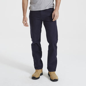 A person wearing a grey t-shirt, Levis Workwear 505 Utility Pant in dark blue with durable oversized pockets, and tan work boots stands against a plain white background. The person's head is not visible in the image.