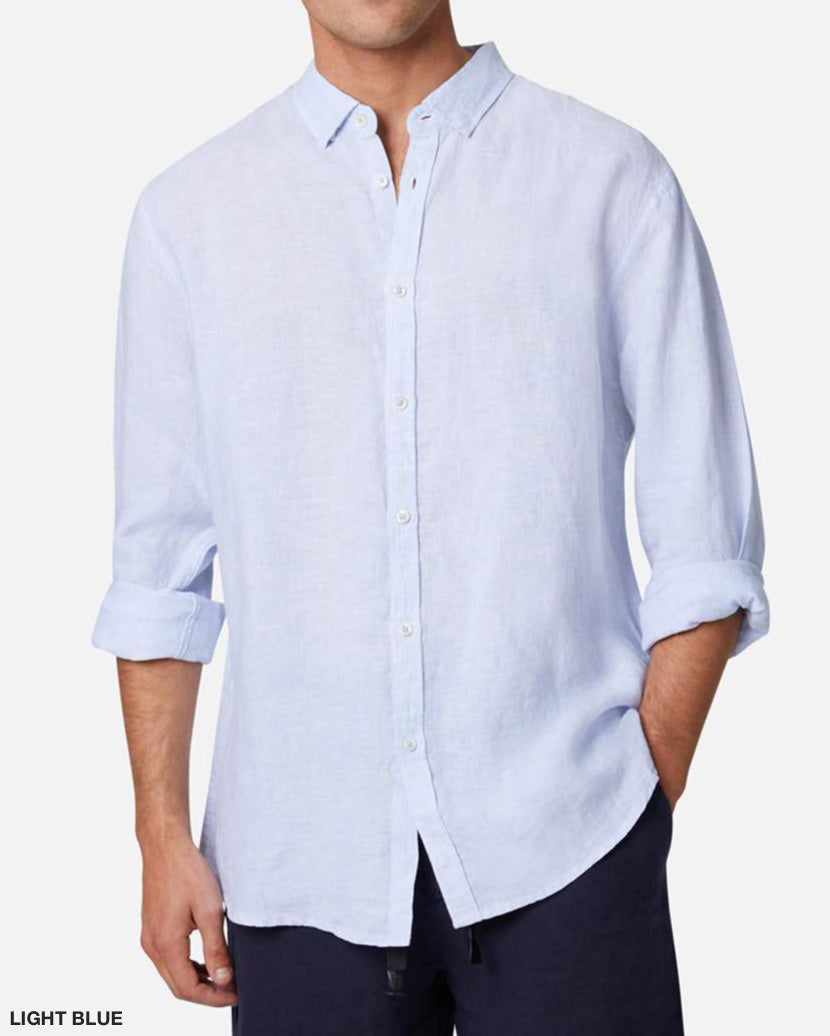 A person wearing the Industrie The Rochecroft Shirt, a light blue button-down made from 100% linen, stands against a plain white background. The long sleeves are rolled up, highlighting the shirt’s relaxed fit and casual style. Only the upper body and part of the arms are visible.
