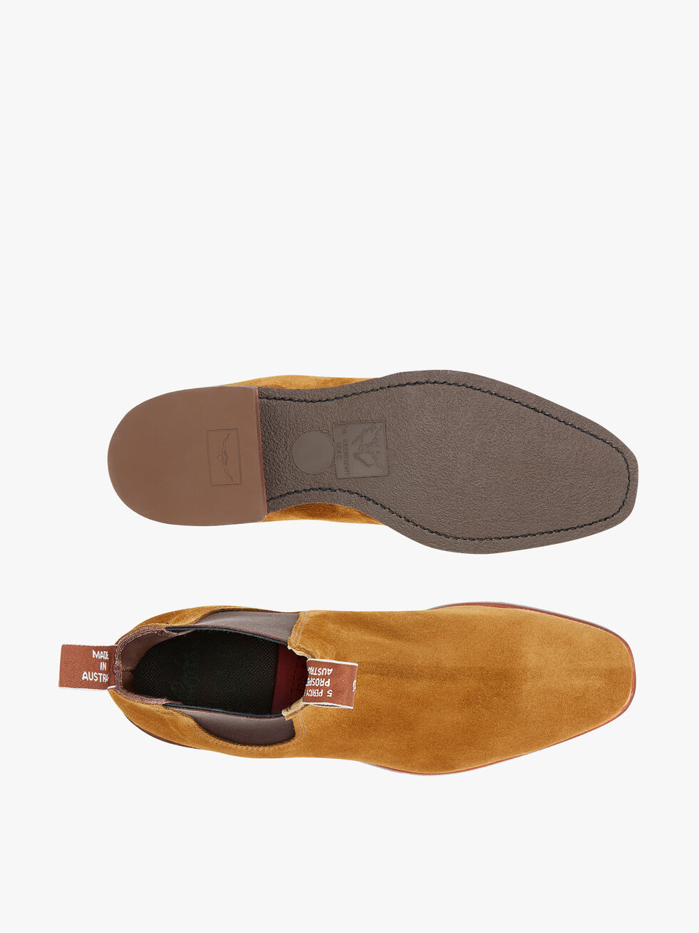 Top and bottom view of a single pair of RM Williams Comfort Suede Craftsman Boots. The boot on the left shows the comfort rubber sole with a textured dark brown area and the brand logo near the heel. The right boot showcases the smooth tan suede leather upper with the pull tab reading "MADE IN ITALY".