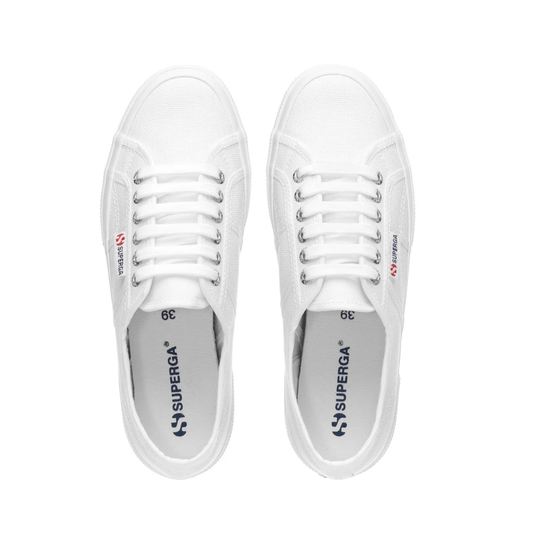 A pair of Superga Cotu Classic Sneakers in white with laces, viewed from above. The brand name in blue graces the side and canvas upper insole. These sneakers feature a classic, minimalist design.