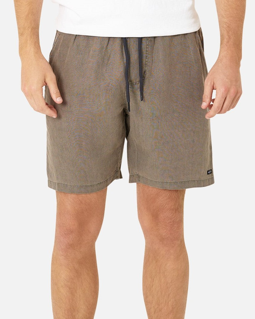 Wearing a regular fit white shirt with Industrie The Marina Linen Short in light brown featuring a drawstring front, the person is photographed from neck to mid-thigh against a plain background, highlighting the stylish and comfortable blend of 100% linen fabric.