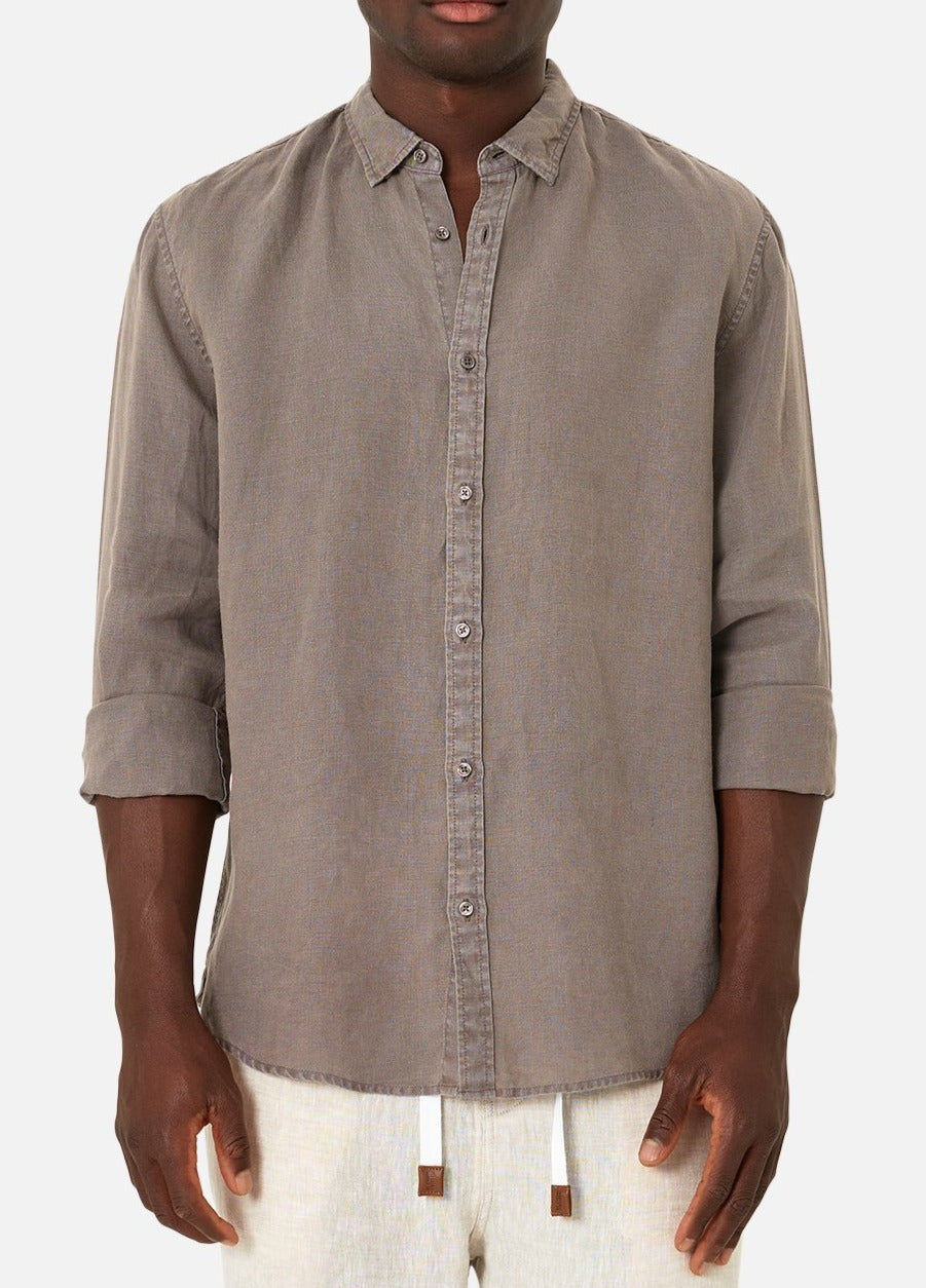 A person models the Industrie The Tennyson Linen Shirt, a relaxed-fit gray long-sleeve made of 100% linen with slightly rolled-up sleeves. It's styled with light-colored pants against a plain white background.