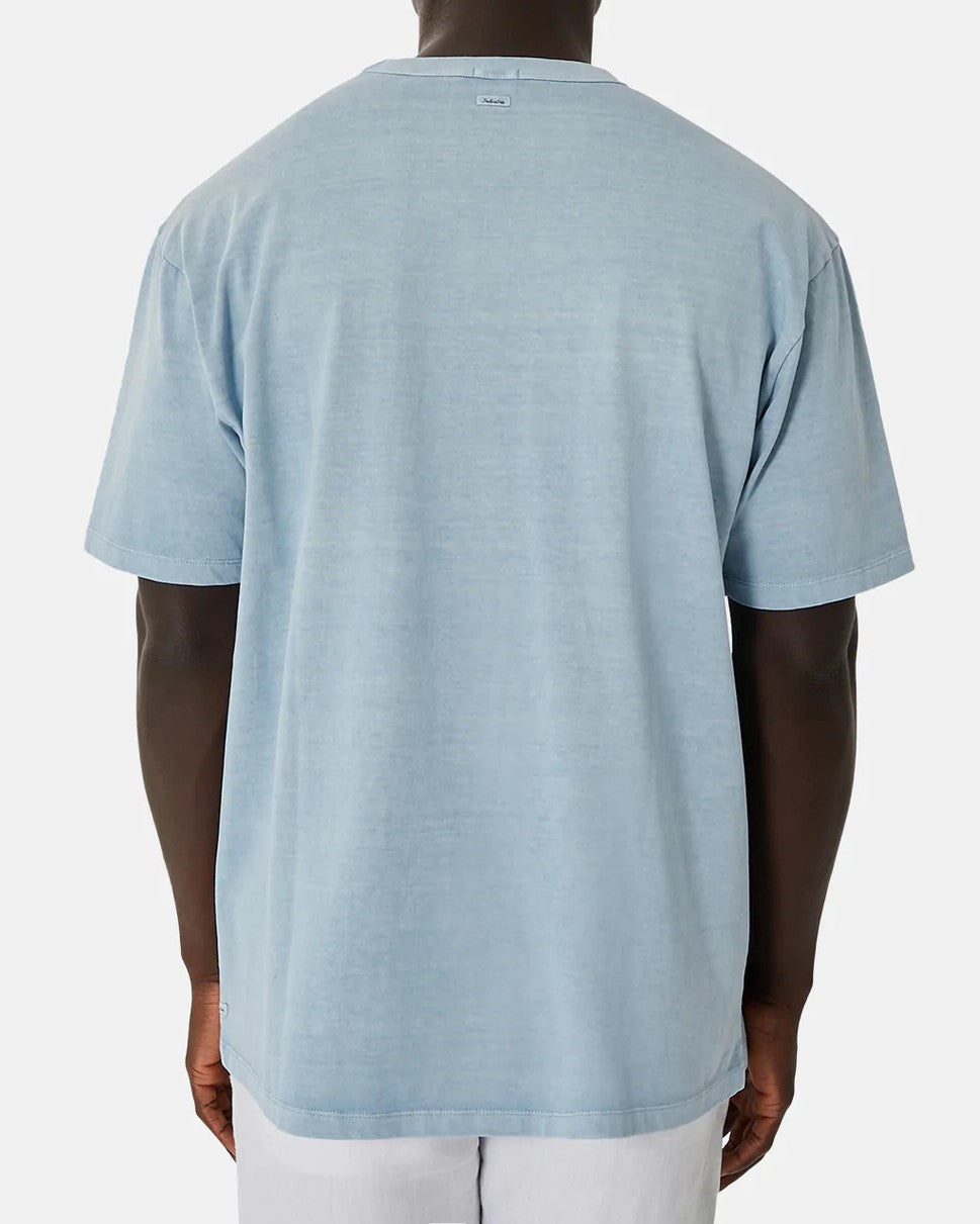 A person wearing the Industrie The Del Sur Tee, a light blue, 100% cotton oversized short-sleeve T-shirt, is shown from the back against a plain white background.